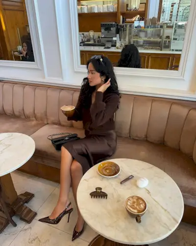 @kristincabat wears a chocolate brown satin skirt, cardigan and patent slingback heels