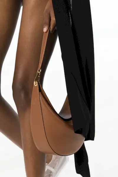 close-up shot of Loewe handbag in the model's hands on the runway