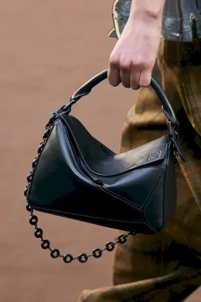 close-up shot of Loewe handbag in the model's hands on the runway