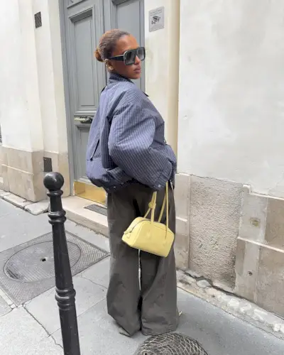 Woman wearing plaid jacket trend fall 2025.