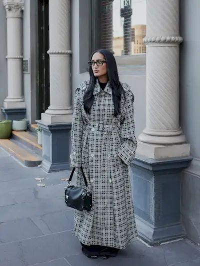 Woman wearing plaid jacket trend fall 2025.