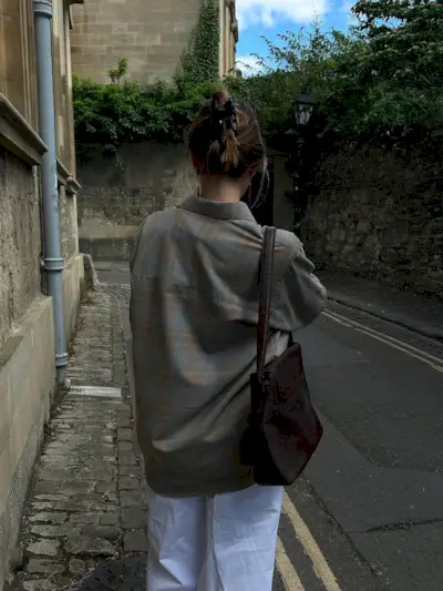 Woman wearing plaid jacket trend fall 2025.