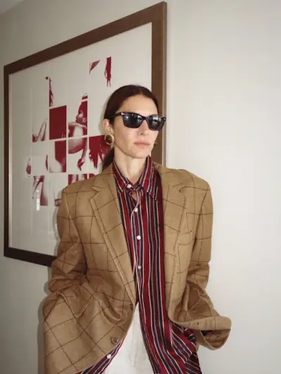 Woman wearing plaid jacket trend fall 2025.