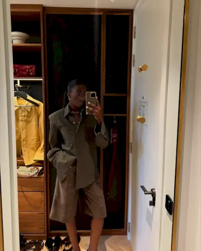 Woman wearing plaid jacket trend fall 2025.