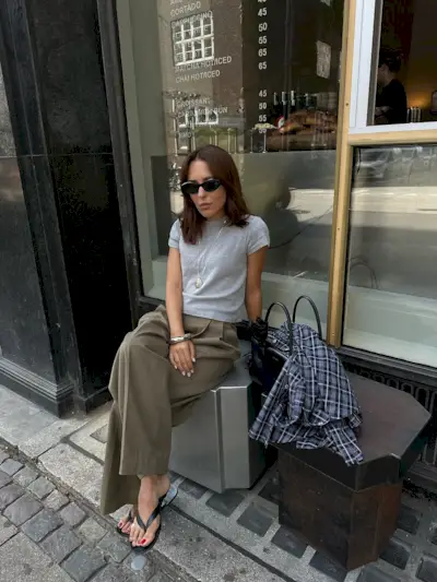 Woman wearing plaid jacket trend fall 2025.