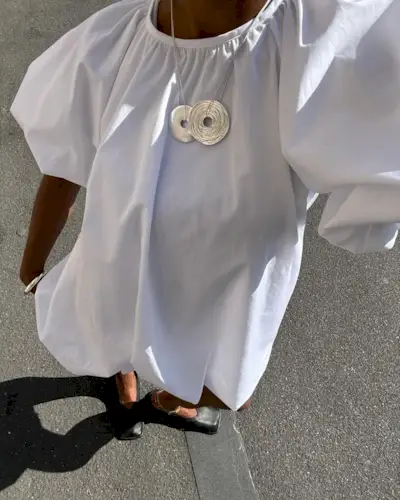 woman wearing crisp white bubble mini dress summer 2025