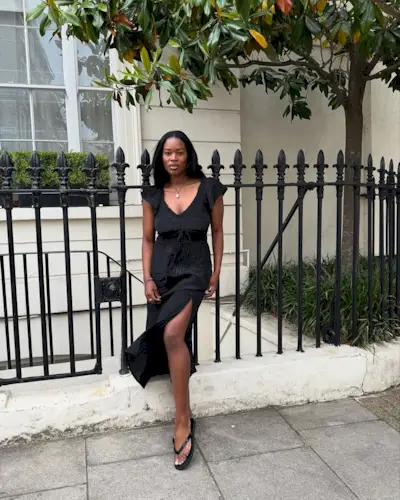 woman wearing black midi dress with fairy sleeves summer 2025