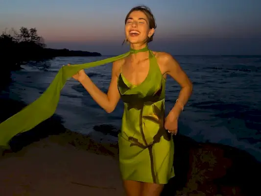 woman wearing green mini dress with neck scarf