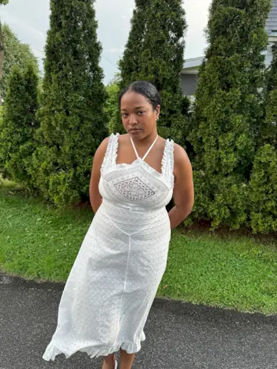 Imani Randolph wearing a white embroidered sundress.