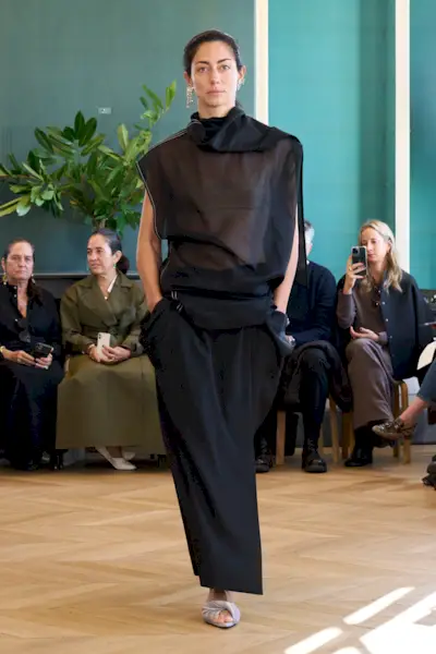 A Carven runway model wearing an all-black outfit in the spring/summer 2025 collection.