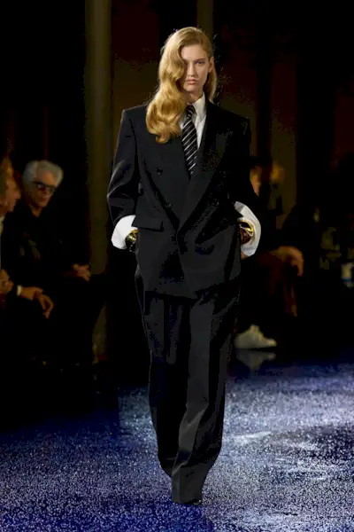 A Saint Laurent runway model wearing an all-black outfit in the spring/summer 2025 collection.