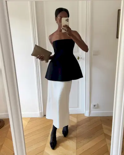 Influencer wears a cream satin skirt.