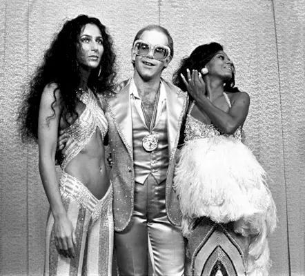 An image of Cher, Elton John and Diana Ross in the 1970s.