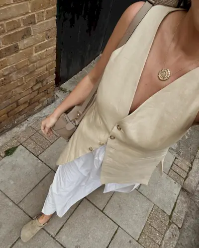 woman wearing vest and maxi skirt