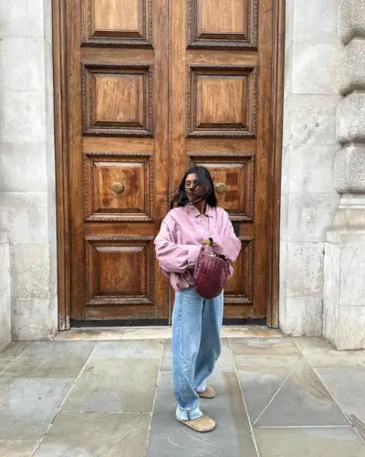 woman wearing pink jacket and birkenstocks
