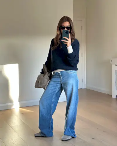 woman wearing wide leg jeans and sweater