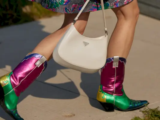 a close up photo of a woman wearing designer cowboy boots