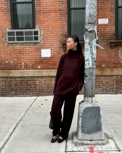 @mimixn wears an elegant winter outfit consisting of a burgundy jumper, matching trousers, and mary jane shoes