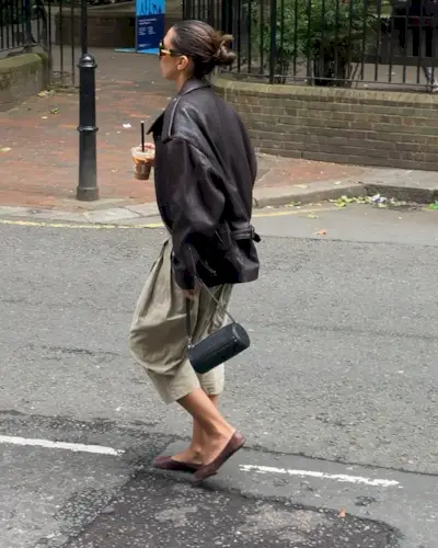 @hannamw wearing a leather jacket and khaki cropped jeans.