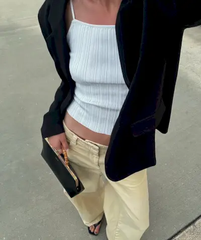 @meganadelaide wearing a blazer, white tank, and khaki jeans.