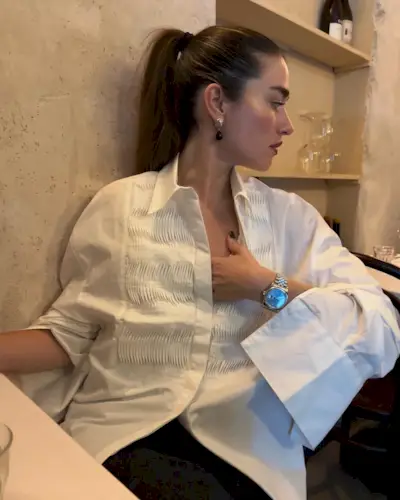 @iliridakrasniqi wearing a white tuxedo shirt and watch