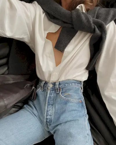 @modedamour wearing a sweater draped over the shoulders