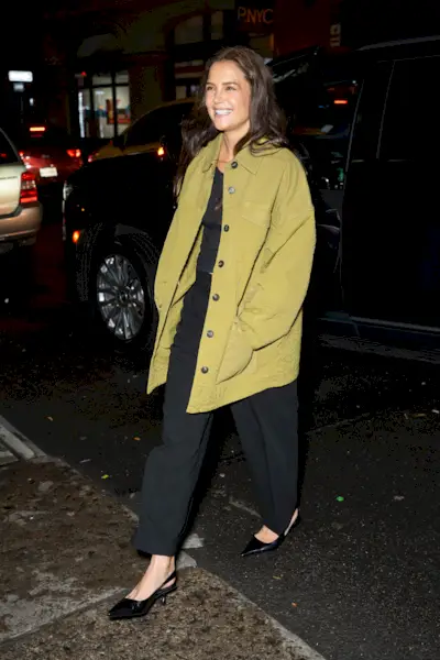 Katie Holmes wearing a green utility jacket and black trousers in NYC