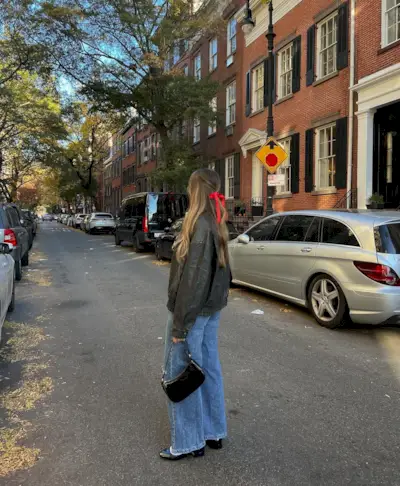 Flared jeans with flats and leather jacket