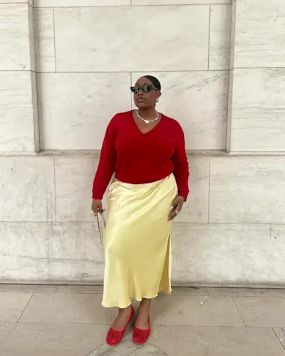 Summer 2025 skirt trends: @aniyahmorinia wears a butter yellow skirt with red accessories