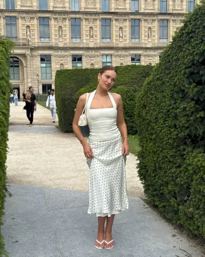 Summer 2025 skirt trends: @megancryder wears a polka dot skirt with flip flops