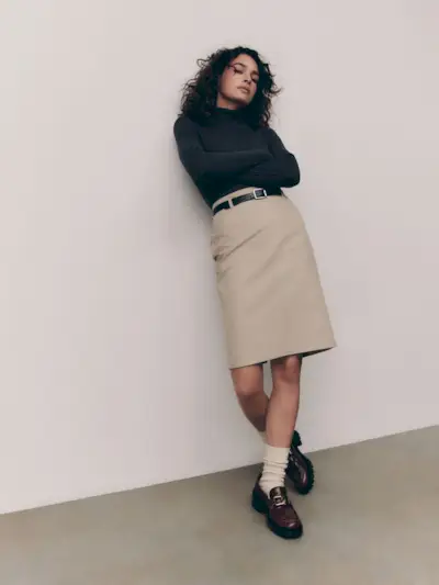 Summer 2025 skirt trends: @nnennaechem wears a knee-length skirt with a blazer and ballet flats