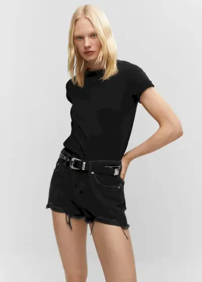 a model wears a black short-sleeve T-shirt with black denim shorts