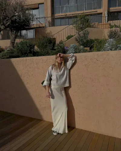 @camillecharriere wearing converse with a slip skirt and striped jumper