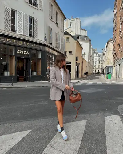 @kimturkington_ wearing Gazelle trainers with a mini skirt and blazer