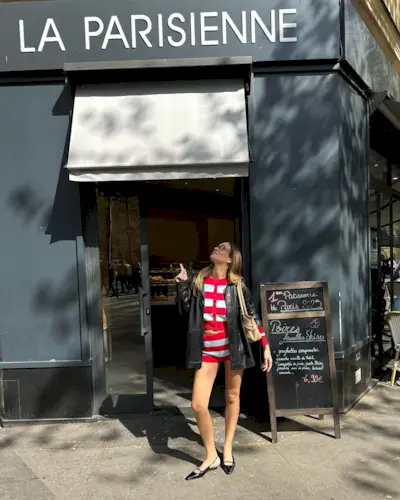 Anne wears a stripe top, stripe knit shorts, and a leather jacket with black leather flats.