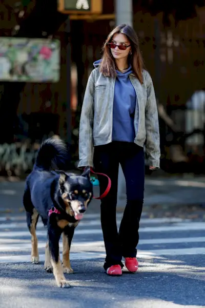 Emily Ratajkowski wearing a pair of red suede Puma Speedcat Sneakers
