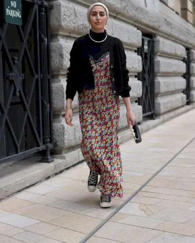 Mira wears her converse with a roll-neck layered underneath a floral-print maxi dress.