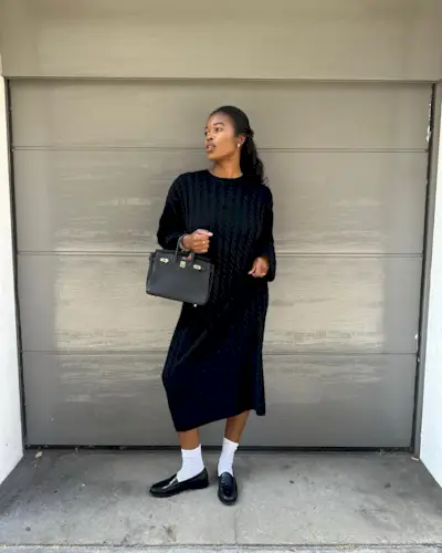 Woman wears knit dress, white socks and black loafers
