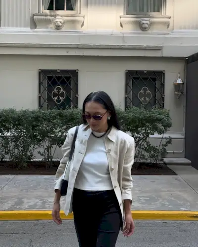 Woman wears linen jacket, white T-shirt and black trousers