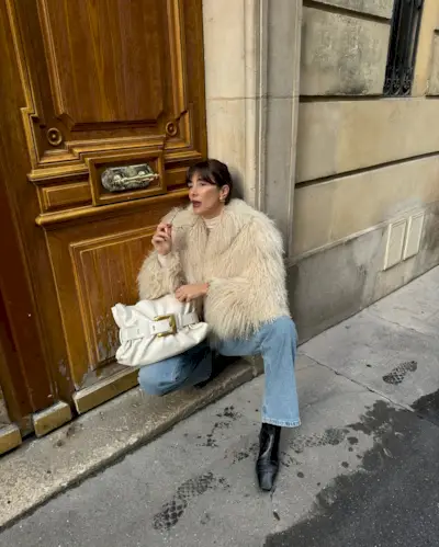 @juliesfi wearing a faux fur jacket and jeans