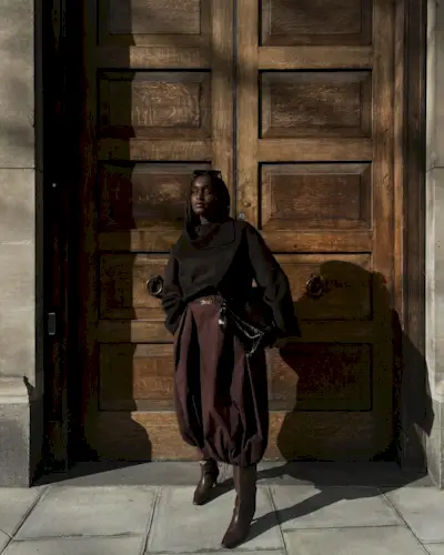 Influencer wears burgundy boots.