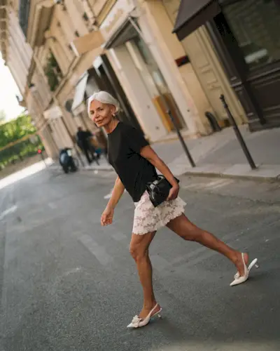 Woman in relaxed t-shirt, lace skirt, and slingback heels