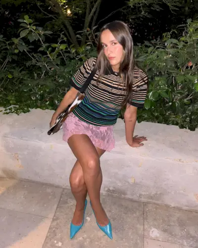 Woman in striped polo and lace skirt