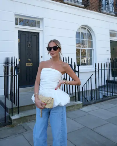 Influencer wears a white strapless top.