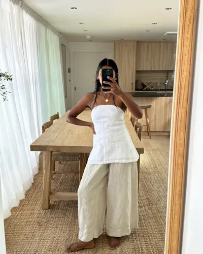 Influencer wears a white strapless top.