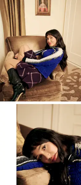 Overcompensating actress Wally Baram poses for portrait at the Plaza Hotel in NYC. She is wearing a long-sleeve smocked blue shirt with the number 21 on the front and a purple plaid miniskirt with black leather boots that hit just below the knee.