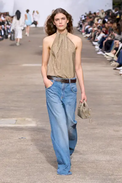 Model wears puddle jeans on the Stella McCartney Spring/Summer 2025 runway.