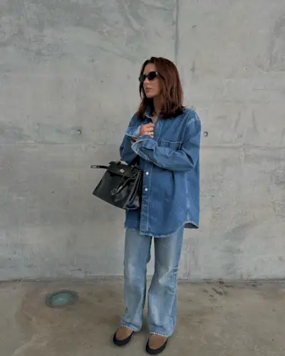 A woman wearing a denim shirt jacket and denim pants
