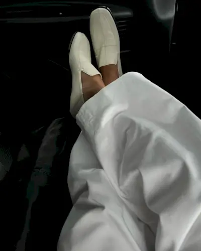 Influencer wears white loafers.