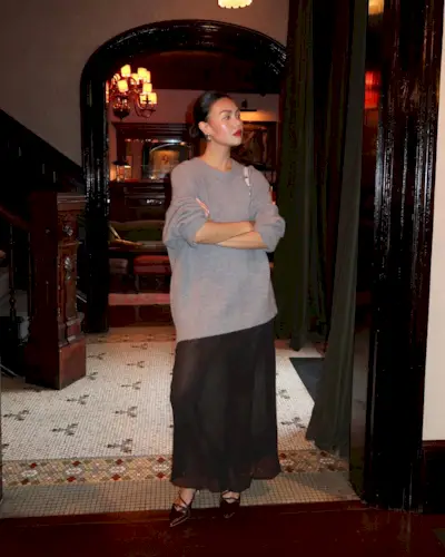  @mimixn wears a chic outfit with a long sheer skirt and oversize sweater with heels and red lipstick in NYC.